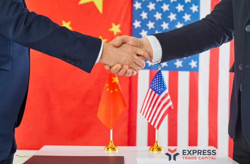 Business handshake in front of U.S. and China flags, representing the 2025 tariff reduction and trade negotiations, with Express Trade Capital logo in view.
